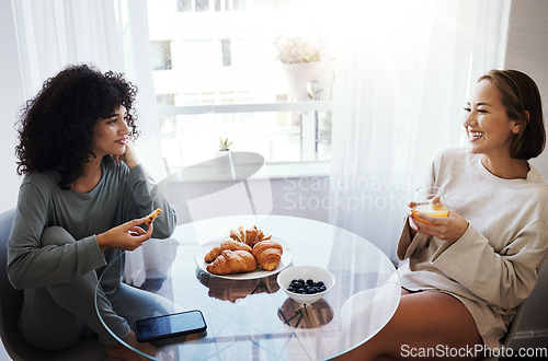 Image of Orange juice, eating breakfast and happy lesbian couple at table in home bonding. Drink, food or croissant of gay women in the morning together for nutrition, diet or healthy interracial relationship