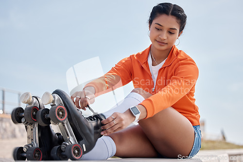 Image of Roller skate, exercise and woman tie shoes outdoor for workout or training with wheels on sidewalk or ground. Fun, sport and start fitness with cardio, rollerskating and safety gear in summer