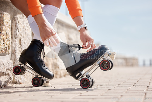 Image of Tie, shoes and hands of woman with roller skates outdoor for exercise, workout or training with wheels on sidewalk. Fun, sport and person start fitness with rollerskating and cardio in summer