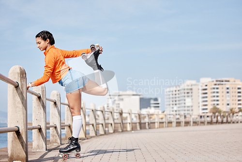 Image of Roller skate, stretching and mockup with a girl at the promenade on a blue sky background for the weekend. Fitness, beach and balance with a young person skating outdoor during summer on banner space