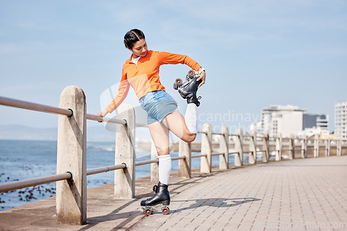 Image of Roller skate, stretching and space with a girl at the promenade on a blue sky background for the weekend. Fitness, beach and balance with a young person skating outdoor during summer on banner mockup