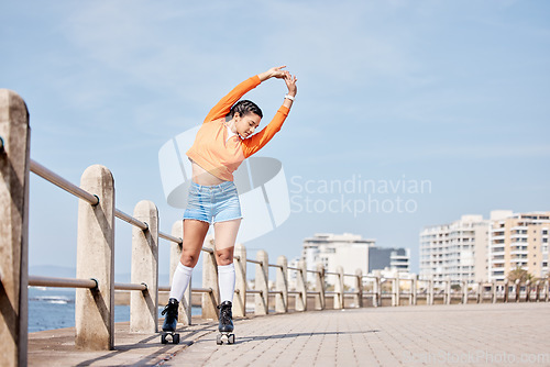 Image of Roller skate, stretching and banner with a girl at the promenade on a blue sky background for the weekend. Fitness, beach and balance with a young person skating outdoor during summer on mockup space