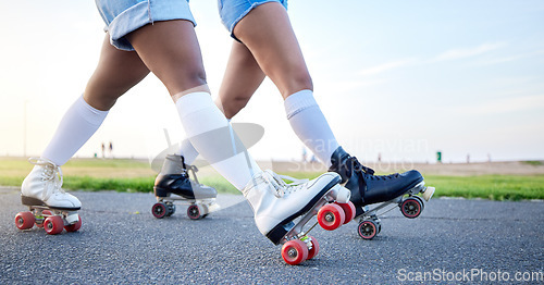 Image of Feet, roller skates and closeup in park, street and outdoor for training, fitness or friends in summer. People, together and skating shoes on asphalt road for exercise, workout or moving for wellness