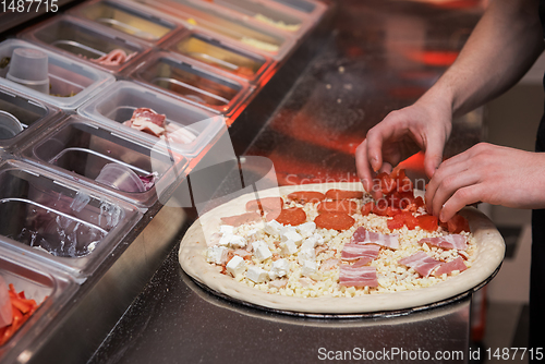 Image of making pizza at kitchen of pizzeria