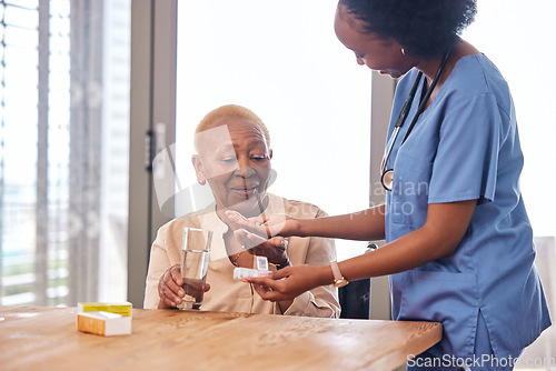 Image of Nurse giving old woman pills in home with water for healthcare, wellness and help. Caregiver, medicine and African patient with glass to drink medical drugs, vitamins and supplements in retirement