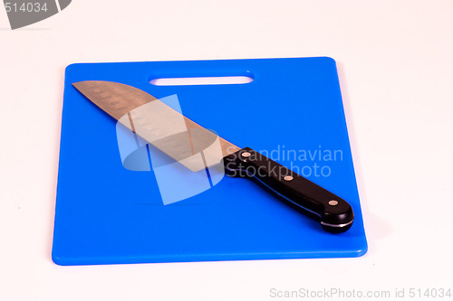 Image of Santoku Knife on a Blue Cutting Board