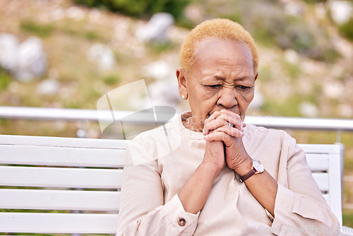 Image of Mature, woman and alone with face in worry for future, retirement or rehabilitation at nursing home. Black, elderly and person in prayer for wellness, diagnosis or treatment at hospital for health