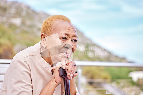 Image of Depression, walking stick and a sad elderly woman on a park bench with nostalgia in nature during summer. Face, summer and a senior person with a disability looking lonely while in the mountains