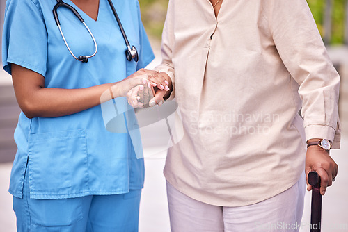 Image of People, hand and holding of elderly for assistance with mobility, support or health with walking. Diverse, women or person with caregiver in hospital, clinic or nursing home in retirement for checkup