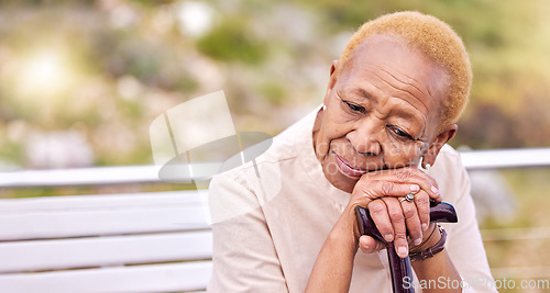 Image of Depression, walking stick and a sad senior woman on a park bench with nostalgia in nature during summer. Face, summer and an elderly person with a disability looking lonely while in the mountains