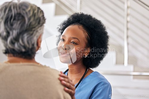 Image of Old woman, nurse and care with conversation, support and happiness with healthcare, smile and treatment. Comfort, African person and medical professional with senior patient, trust and caregiver