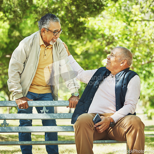 Image of Senior friends, men and support on park bench, talk and bonding outdoor to relax. Happy elderly people sitting together in garden, comfort in communication and conversation in nature for retirement