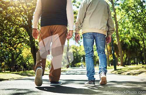 Image of Walking, park and back of men outdoors for wellness, fresh air and health in retirement. Friends, fitness and legs of people on path in nature to relax for training, exercise and cardio workout