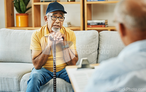 Image of Doctor, consultation and senior man on sofa with walking stick or discussion of physical therapy and checklist. Therapist, consulting and talking to elderly patient on couch in rehabilitation office