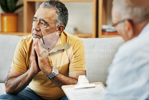 Image of Elderly man talking to a psychologist at a mental health, psychology and therapy clinic for session. Psychological therapist with clipboard for counseling checklist with senior male patient in office