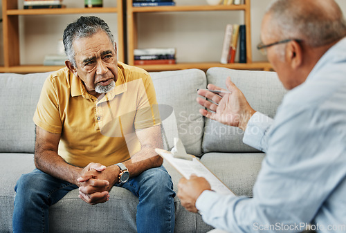 Image of Senior man talking to a psychologist at a mental health, psychology and therapy clinic for session. Psychological therapist with clipboard for counseling checklist with elderly male patient in office