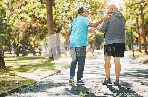 Image of Senior friends, walk and talk in park in retirement, fitness and wellness in outdoors. Elderly people, talking and chatting in nature, workout and cardio for health, supportive in conversation