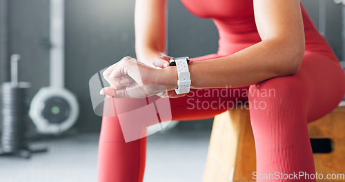 Image of Gym, hands and watch to monitor fitness, check training app or exercise progress. Closeup, sports and person or athlete with the time at a club for wellness results, achievement or exercise tracking