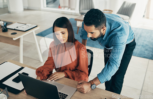 Image of Employee, manager and office with laptop with creative director, above and feedback on project. Diversity, man and woman for consulting by technology, performance review and concern with job progress