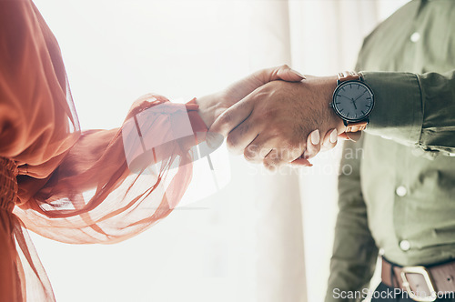 Image of Creative people, handshake and teamwork in meeting, b2b deal or partnership together at office. Closeup of man and woman shaking hands for startup, introduction or thank you in agreement at workplace
