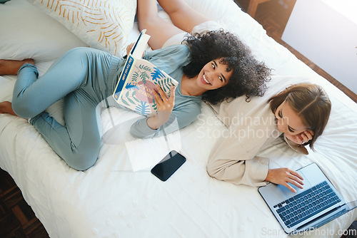 Image of Laptop, morning and a lesbian couple relax in bed while together in their home on the weekend. Reading, computer and book with happy lgbt woman with her girlfriend in the bedroom from above for love