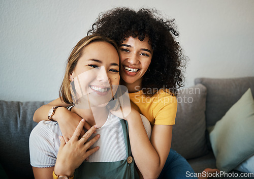 Image of Lesbian, couple and portrait of hug on sofa in home, living room or apartment with love, support and happiness. Lgbt, women and embrace together with smile on face on lounge, relax and couch in house