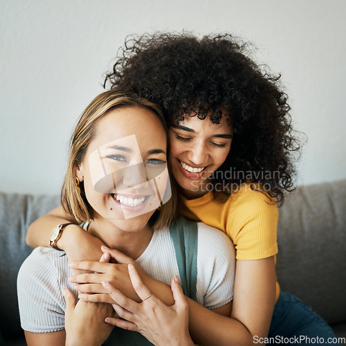 Image of Lesbian, couple and portrait of hug on sofa in home, living room or apartment with love, support and happiness. Lgbt, women and relax together with pride, confidence and smile on face in house