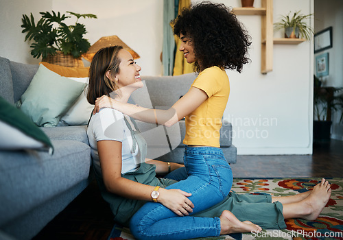 Image of Lesbian, couple and women relax together on floor at home, bonding with love and pride, happiness and care. Support, trust and healthy relationship, LGBTQ with smile and romance in living room