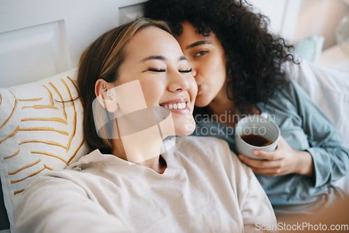 Image of Women, lesbian and kiss in bedroom with happiness, romantic and intimate for marriage with love. LGBTQ, diversity and bisexual couple with communication for support and smile at home with respect