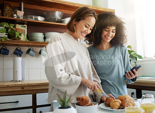 Image of Lgbtq, couple and women with smartphone and cooking with happiness in kitchen for breakfast or nutrition in morning. Food, people and home with romance and lesbian or natural face for care or love