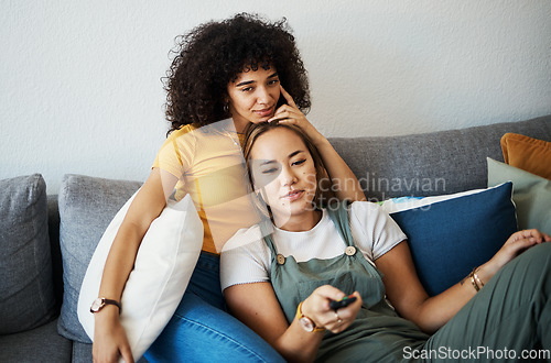 Image of Love, relax and a gay couple watching tv on a sofa in the living room of their home together. Television, LGBT and a woman with her lesbian girlfriend for movie on a subscription streaming service