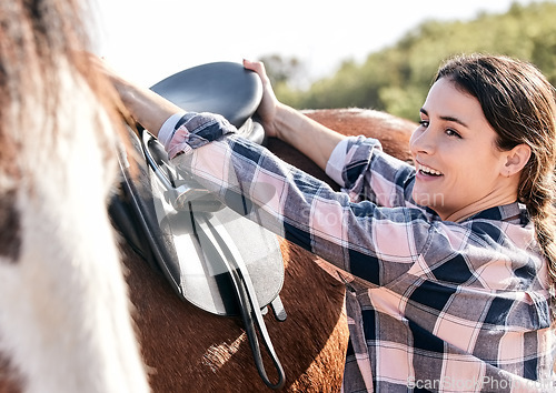 Image of Horse, happy rider and woman with saddle on ranch for animal care, training and riding on farm. Agriculture, countryside and person with seat for stallion for practice, freedom and adventure outdoors