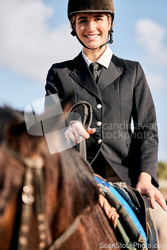 Image of Portrait, equestrian and a woman jockey with her horse on a ranch for sports, training or a leisure hobby. Smile, riding or competition and a happy young rider in uniform with her stallion outdoor