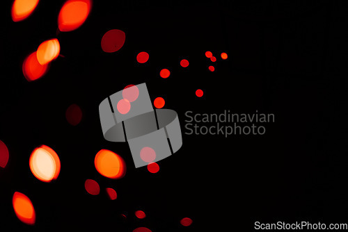 Image of Red, lights and bokeh in a studio with dark background for celebration, event or party. Confetti, glitter and color sparkles for magic, shine or glow for festive by black backdrop with mockup.