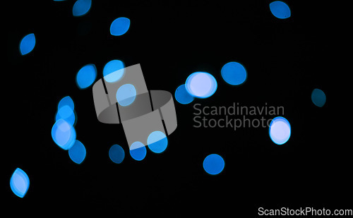 Image of Blue, glitter and bokeh in a studio with dark background for celebration, event or party. Confetti, lights and color sparkles for magic, shine or glow for festive by black backdrop with mockup.