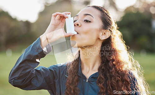 Image of Health, woman and asthma pump outdoor to breathe on sports field in nature for lungs risk or breathing. Fitness, person and hand holding inhaler for wellness, relief and oxygen for prescription