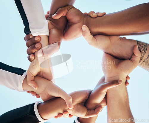 Image of Hands, link or chain with people on team, collaboration and solidarity with support and connection low angle. Community, synergy and huddle with mission in group, meeting and communication of goals