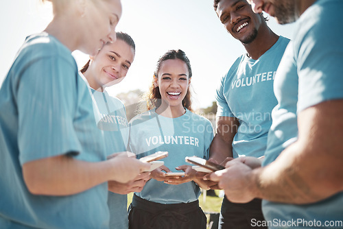 Image of Volunteer team, phone and portrait of people in park for social media, online chat or charity website update. Community service, teamwork and happy group on smartphone for cleaning or recycle outdoor