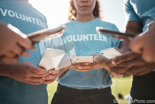 Image of Volunteer, park and hands of people with phone for social media, online chat and charity website. Community service, teamwork and men and women typing on smartphone outdoor for recycle cleaning blog