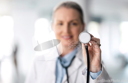 Image of Senior woman, doctor and futuristic with stethoscope, smile and appointment with bokeh background. Mature person, medical professional or happy employee with hospital equipment, worker and healthcare