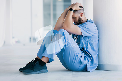 Image of Doctor, stress and sad on floor for hospital mistake, healthcare fail or bad news of clinic death. Mental health of medical worker, tired man or nurse with headache, depression and anxiety or fatigue