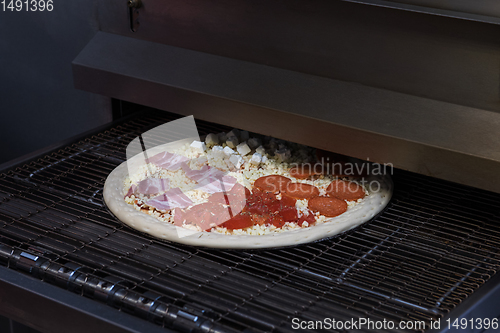 Image of Preparing pizza in oven