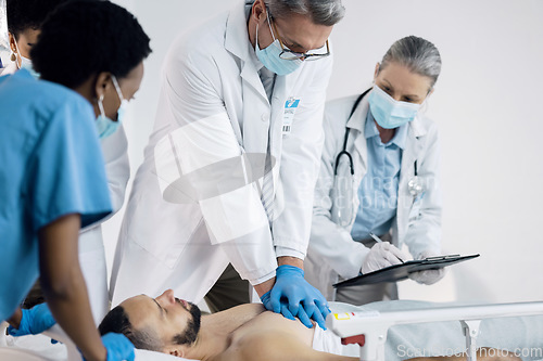 Image of CPR, emergency and doctor with patient in hospital for medical service, first aid and surgery. Healthcare, teamwork and man do chest compressions for injury, serious accident and wellness in clinic