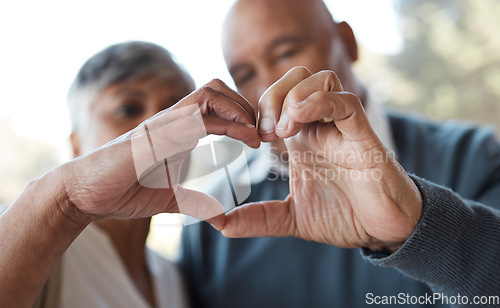 Image of Marriage, heart hands and senior couple with care, romance and romance with bonding, relationship and retirement. Face, old woman and elderly man with love symbol, kindness and health with trust