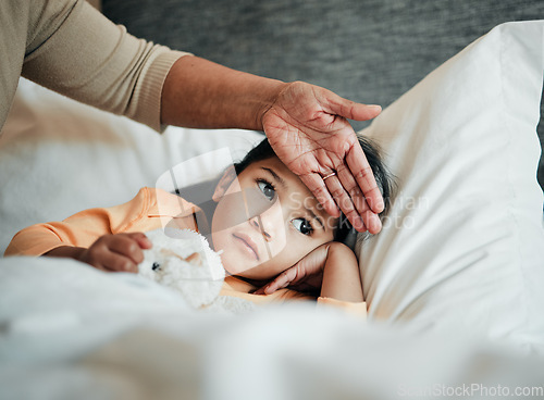 Image of Girl kid, check for fever and sick in bed with hand on head, health and wellness, parent monitor temperature at home. Headache, illness and young child with the flu, medical help and support of mom