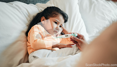 Image of Girl child, thermometer for fever and sick in bed, health and wellness, parent monitor temperature at home. Headache, illness and young kid with the flu virus, medical help and support in bed