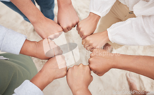 Image of Family, people and fist bump circle outdoor on beach for team building, support and unity for trust. Hands, men and women on sand in nature for community, motivation or connection with solidarity