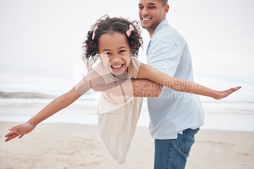 Image of Dad, daughter and beach while playing, airplane and smiling for fun, excitement and happiness on vacation, holiday and memories. Freedom, fly and joy with blue skies, outdoor and bonding together