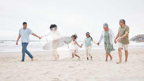 Image of Big family, walking and holding hands at a beach with support, care and trust in nature. Love, security and children with parents and grandparents at the ocean with solidarity, unity and freedom