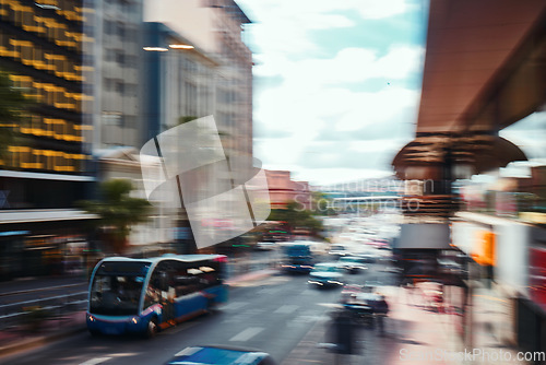 Image of Busy city, road and cars in motion blur for morning traffic, travel and transportation in CBD. Urban commute, office building and street with bus stop, people on sidewalk and fast journey to work.